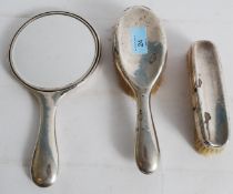 Three hallmarked silver dressing table set items to include two clothes brushes and matching