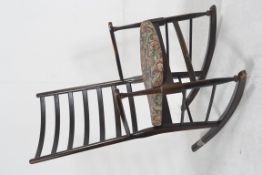 A 1940's dark oak Shaker style country rocking chair. Raised on turned supports with shaped elbow