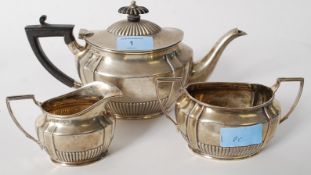 An Edwardian hallmarked silver teapot, sugar bowl and creamer by Henry Stratford. Sheffield