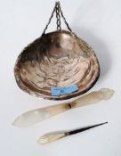 A silver plated bon-bon dish in the form of a clam shell along with a mother of pearl letter