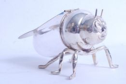 A silver plate and glass honey pot in the form of a bee, the clear glass back with winged hinged