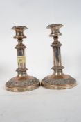 A Pair of silver plate on copper candle sticks on circular bases raised in relief Sheffield candle