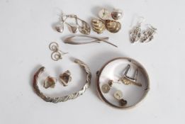 A collection of silver items to include bangles, ear rings etc