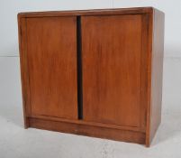 A 1940`s oak twin door cupboard similar to stag c-range having a black upright flash to the centre