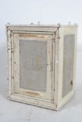 A vintage 20th century painted metal food safe of square form having full length mesh door with