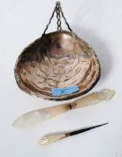 A silver plated bon-bon dish in the form of a clam shell along with a mother of pearl letter opener