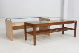 A 1970`s retro teak coffee table with slatted magazine rack to underside. Together with a