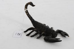A bronze cold cast figurine in the form of a scorpion with raised tail.