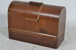 A vintage early 20th century singer sewing matching together with accessories having hood case