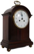 A 19th century mahogany bracket clock with enamel face having French 8 day movement set within (