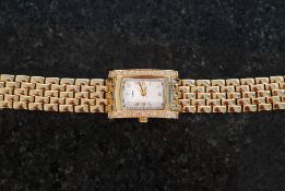 A ladies gold plated and set stone cocktail watch