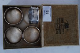 A set of four silver hallmarked napkin rings in original retailers box Kemp Bros