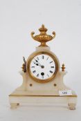 A vintage onyx and gilt painted mantel clock with gilt painted highlights standing on four feet.