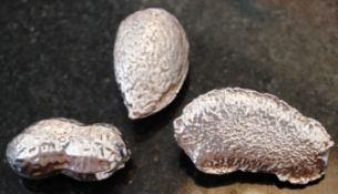 A collection of three vintage white metal ( continental silver ) models of nuts - walnut, peanut etc