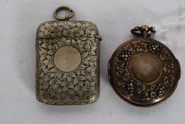A 19th century hallmarked silver vinaigrette of rococo form with central monogram panel and fret