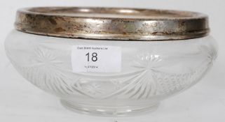 A hallmarked silver rim cut glass fruit bowl with etched St louis style design. The silver rim being