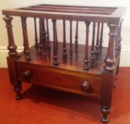 A Victorian solid mahogany canterbury raised on turned supports having single drawer to base with