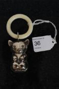 A Victorian style babies rattle in the form of a cat.