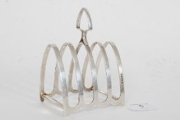 A hallmarked sterling silver toast rack by NB, with L date letter. weighing 3.6 ounces