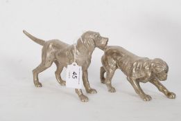 A pair of 20th century cast metal figurines in the form of hunting dogs / hounds