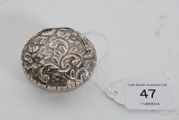 A Victorian hallmarked rococo silver pill box having central hinged lid. Stamped to interior for