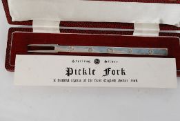 A 20th century reproduction hallmarked silver pickle fork with certificate in box.