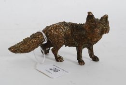 A 20th century gilt painted bronze figurine in the form of a bushy tailed fox.