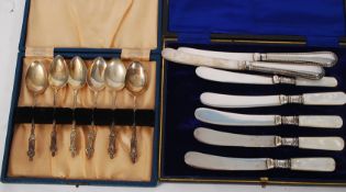 A boxed set of silver apostle spoons together with a boxed set of silver fruit knives having