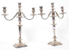 A  good pair of 20th century silver plate twin branch  candelabra being raised over terraced base