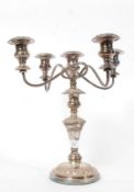 A good single  silverplate four branch candelabra candlestick being raised on a terraced base with