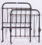 A Victorian cast iron single bed frame having original runners uniting the head and foot boards.