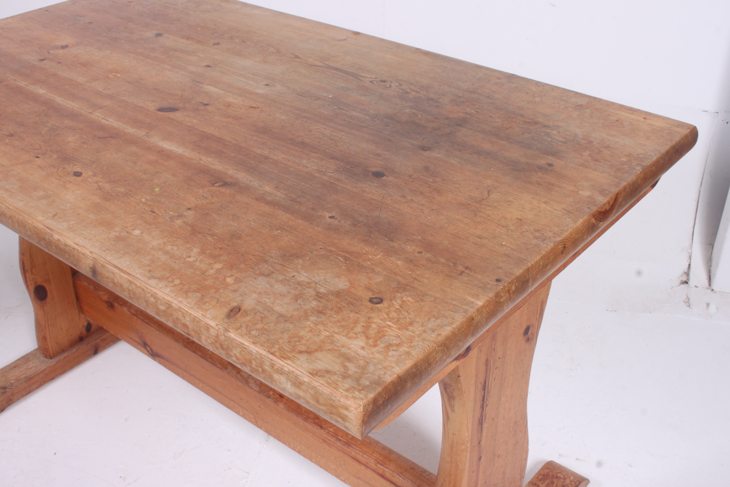 A contemporary pine refectory dining table on shaped supports united by stretcher. 74cm x 121cm x - Image 2 of 2