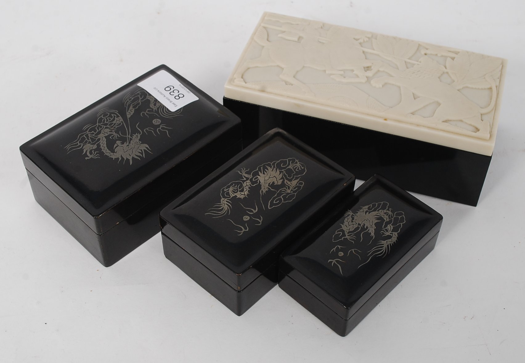 A Collection of Japanned laquered graduating boxes with decorative tops having pictorial design to