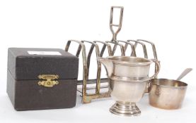 A hallmarked silver remembrance engraved 4037 ewer, pair of hallmarked silver napkin rings, toast