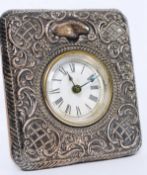 An Edwardian silver hallmarked rococo watch frame having inset clock on easel back. Makers WHYS