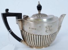 A hallmarked silver and ebonised handled teapot.  Weight 254 grams