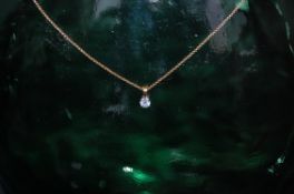 18ct gold chain with .33ct drop pendant measures 16 inches.
