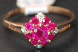 9ct gold 13 stone diamond and ruby ring 0.2cts. Size M.5
