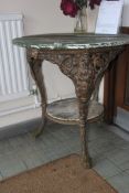A 19th century shabby chic cast iron pub table having mahogany top being painted