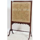 A good Edwardian mahogany fire screen raised on turned legs united by stretchers. The inset silkworm