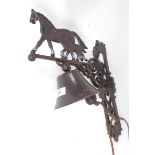 A 20th century cast iron wall hanging bell in the form of a horse.