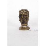 A vintage style brass letter / document seal in the form of a bearded man.