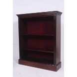 A Victorian large solid mahogany open window bookcase raised on a plinth base with shelves to centre