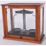 A cased set of mid 20th century Industrial scales by Griffin. Set within a mahogany and glass case.