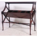 An Edwardian mahogany book trough. The moulded top over five angular divisions being raised on