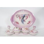 An Edwardian blush pink floral pattern dressing table set comprising of tray, trinket pots etc.