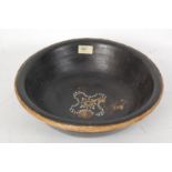A 19th century carved wood ebonised Chinese oriental bowl, with intricate straw work rim and brass