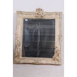 A 20th century Italian cherub adorned shabby chic wall mirror of resin construction being highly