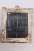 A 20th century Italian cherub adorned shabby chic wall mirror of resin construction being highly