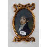 An antique style gilt framed printed portrait miniature of a young gentleman.